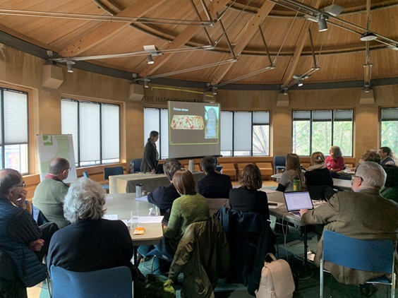 An image of Memory Club participants gathered together watching a presentation.